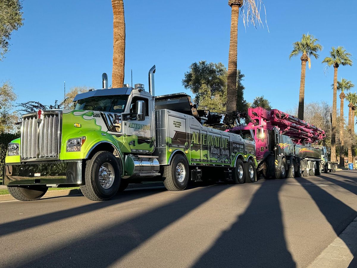Two tow trucks are parked on the side of the road.
