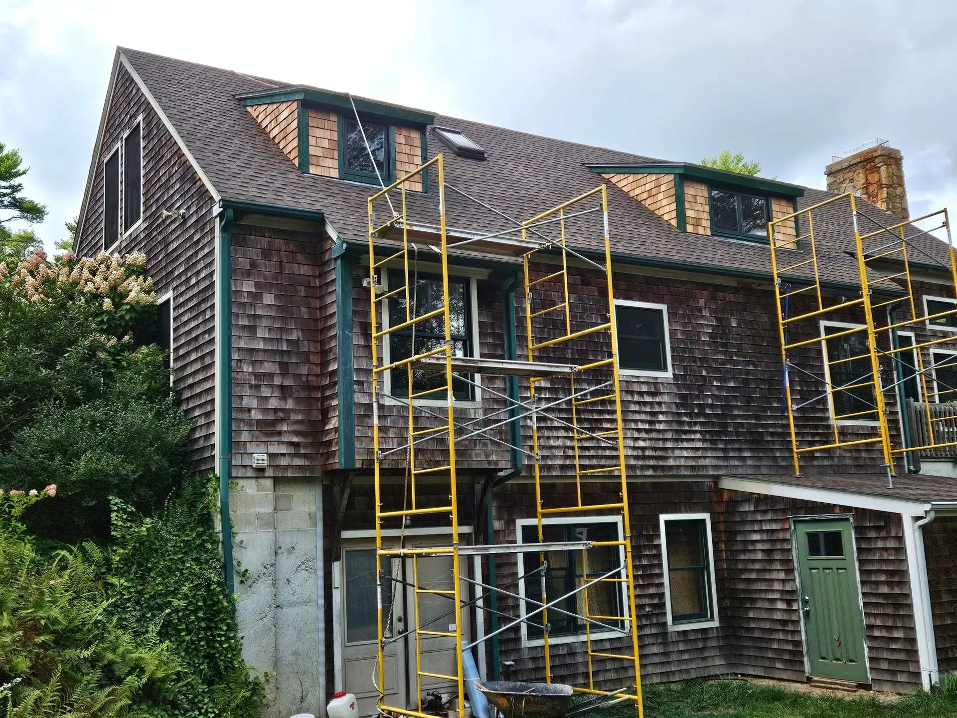 Old house with yellow scaffolding during exterior repairs