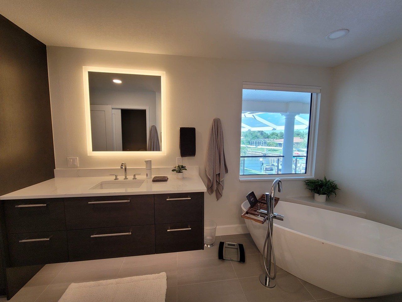 free standing tub and back lit mirror