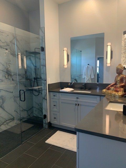 sink mirror with sconces and glass shower