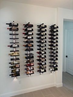 A row of wine bottles hanging on a wall