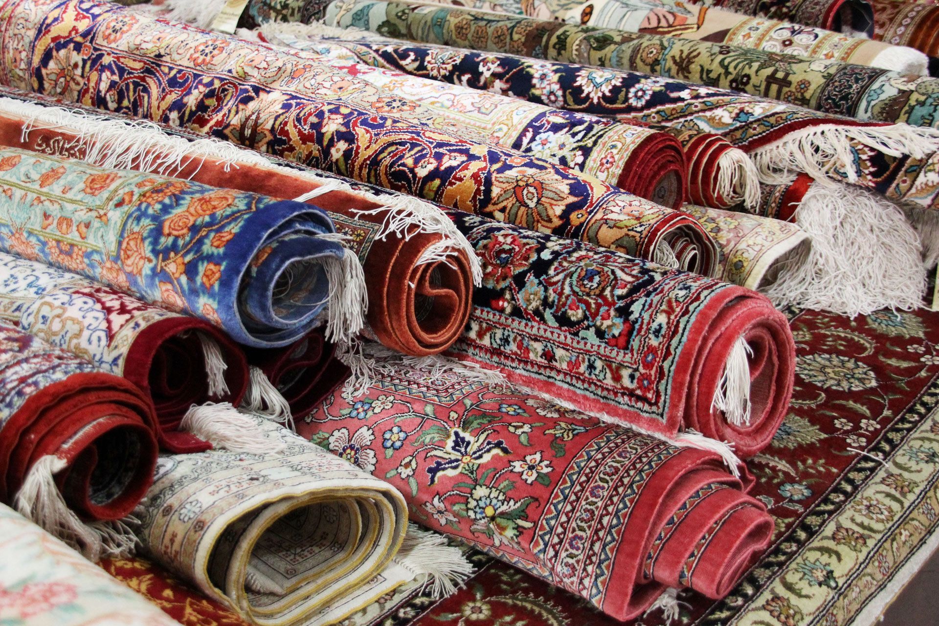 a bunch of rugs are stacked on top of each other on a table