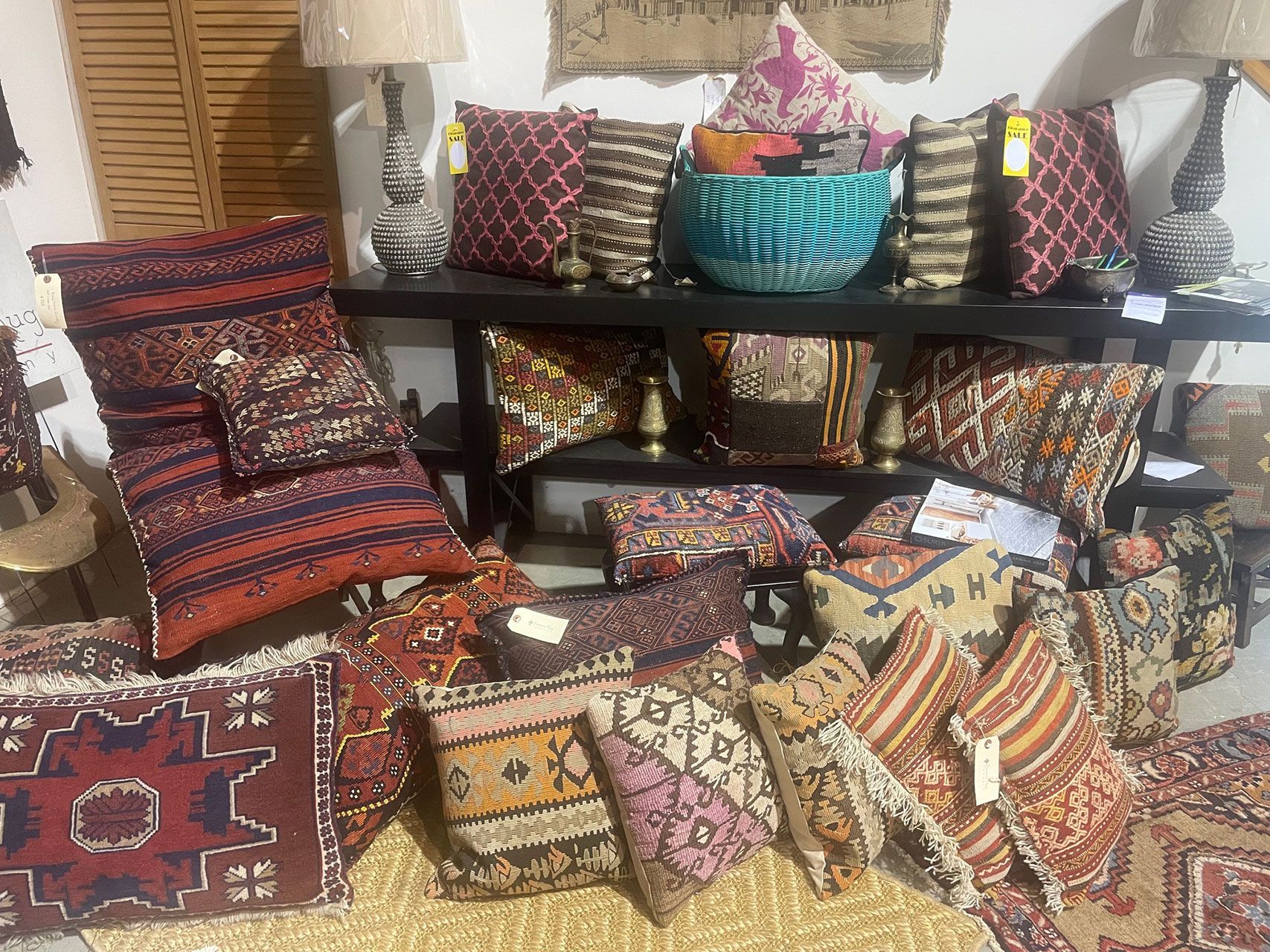 A room filled with lots of colorful pillows and rugs