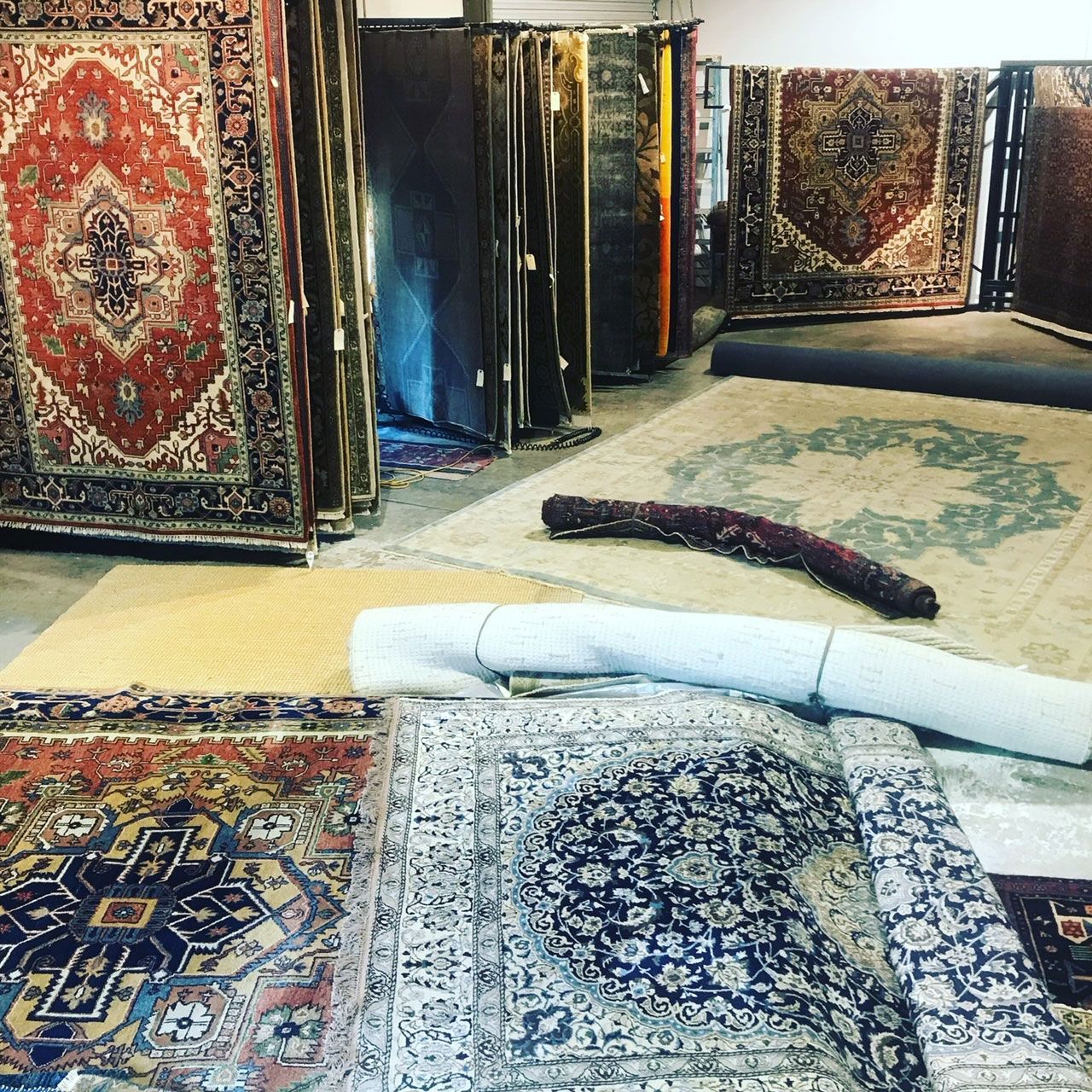 A room filled with lots of colorful rugs