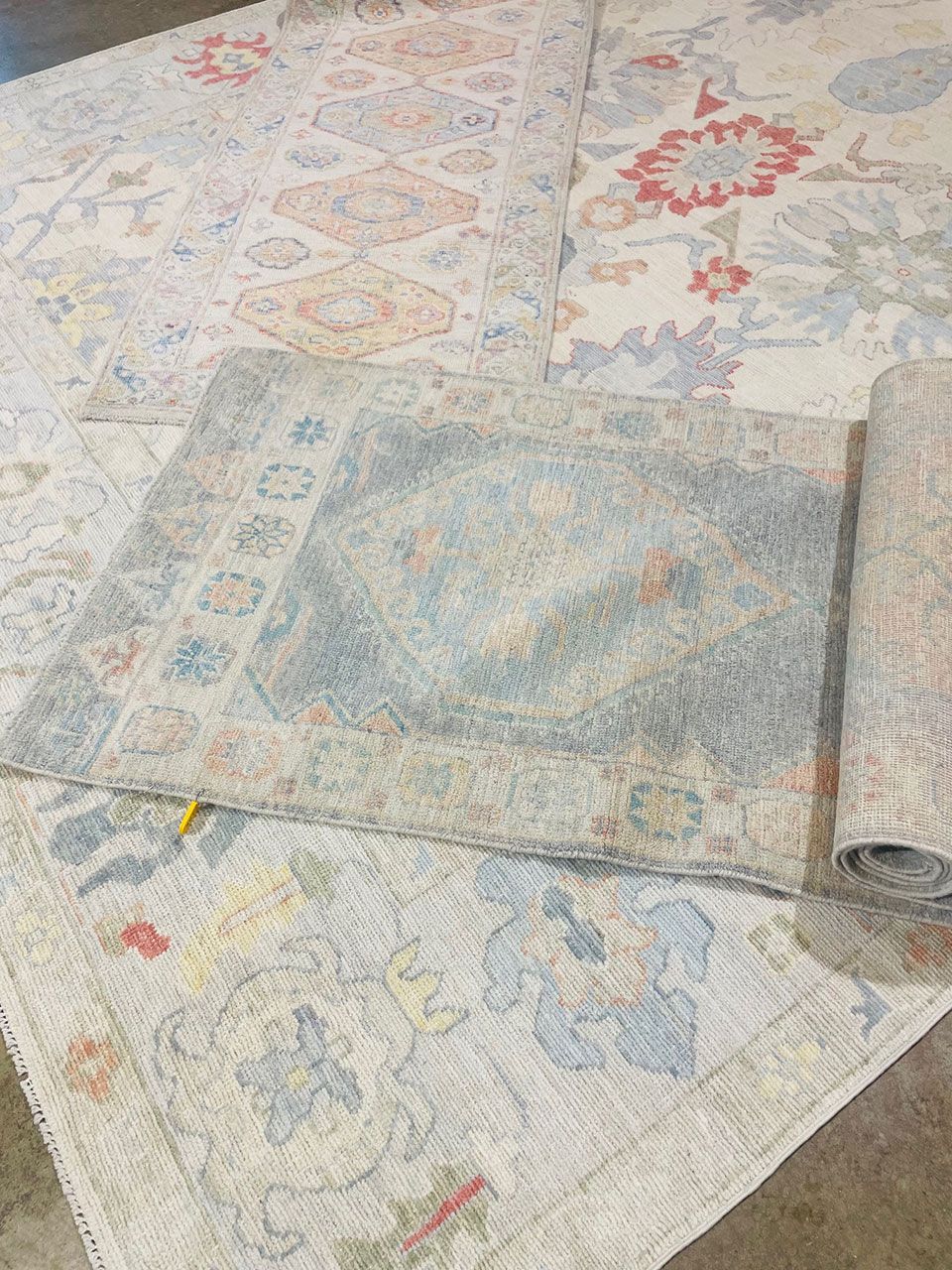 A bunch of rugs are sitting on top of each other on a table