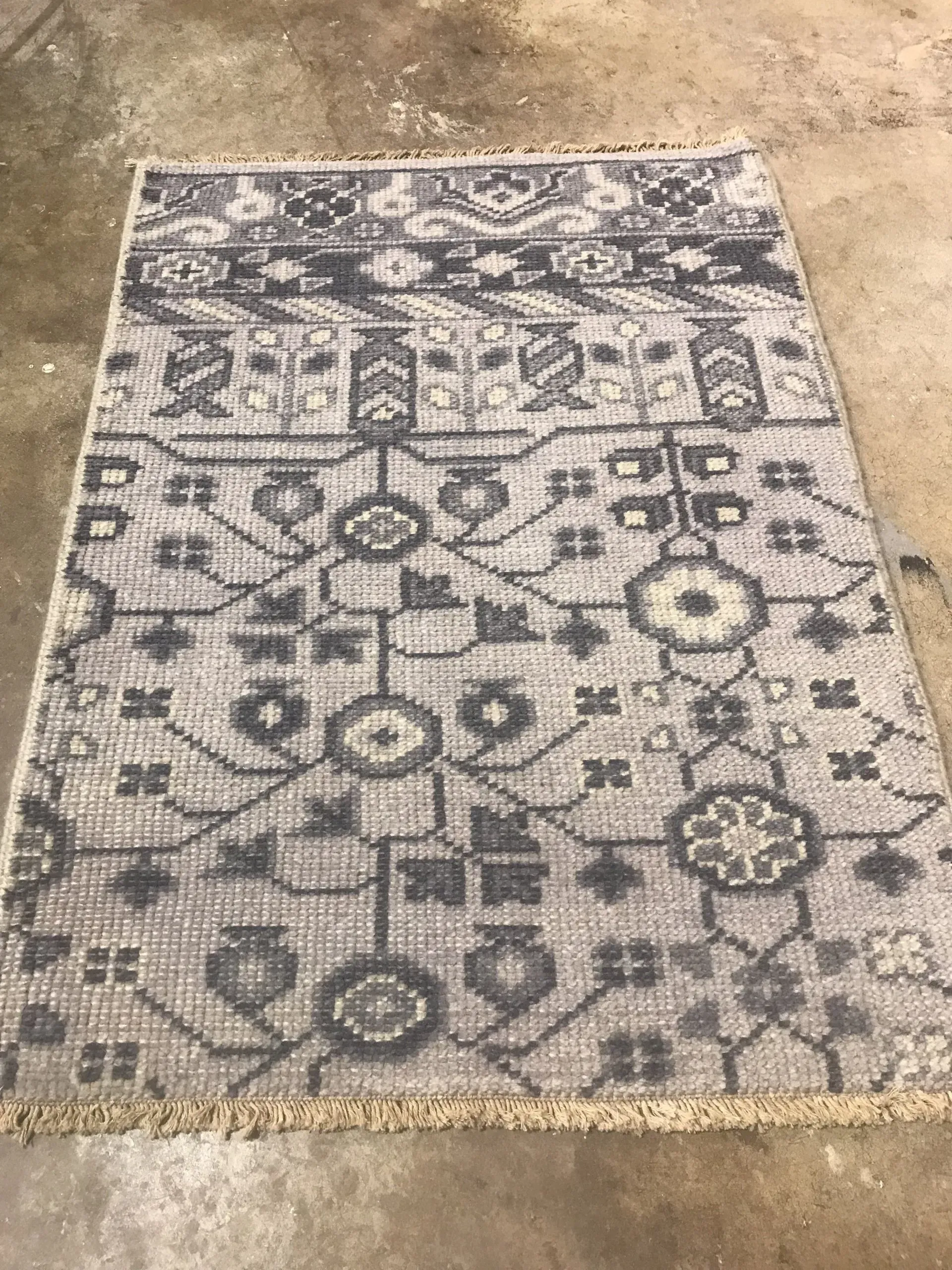 A rug with a detailed pattern on it.