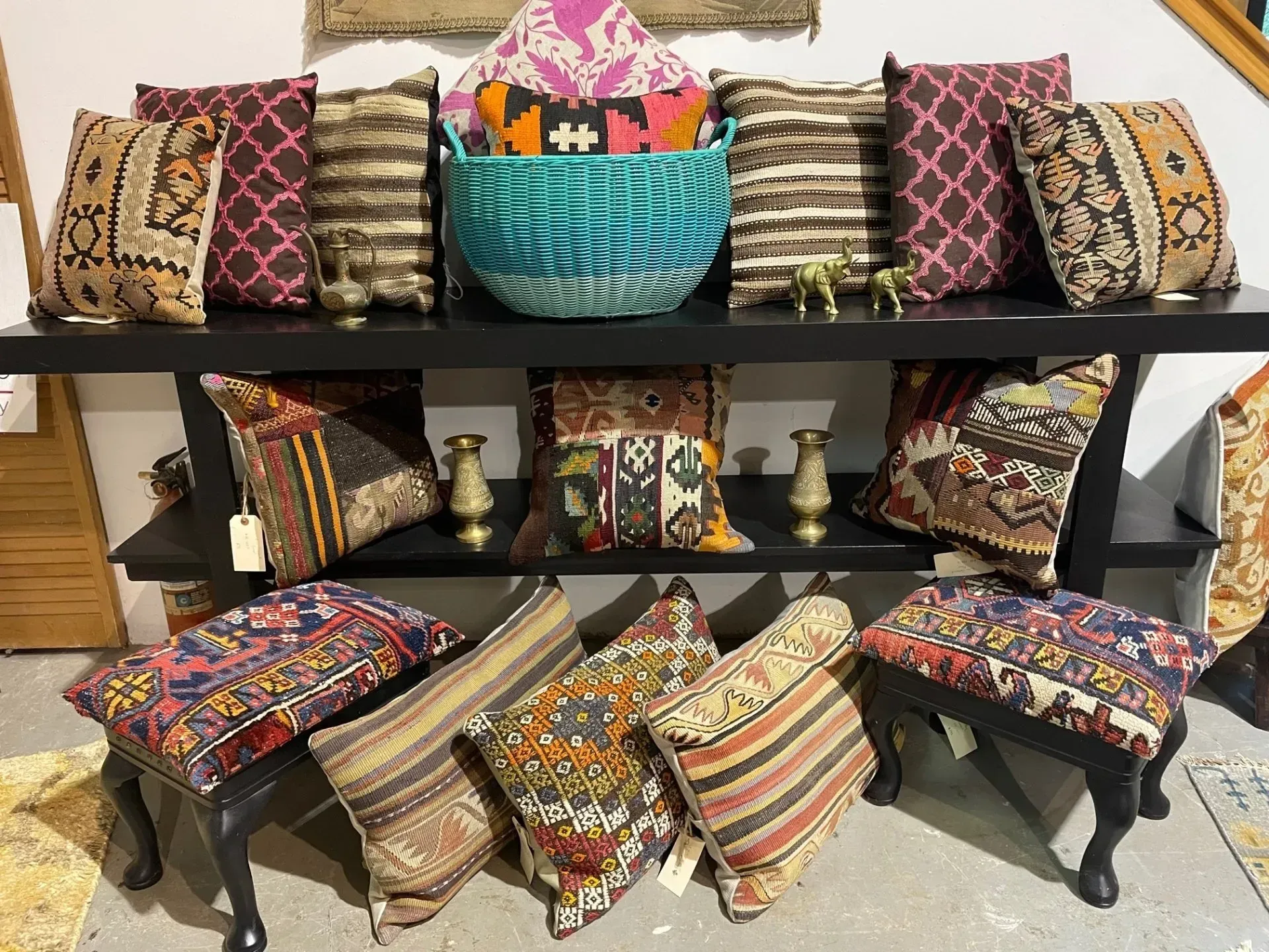 A bunch of colorful pillows are sitting on a table.