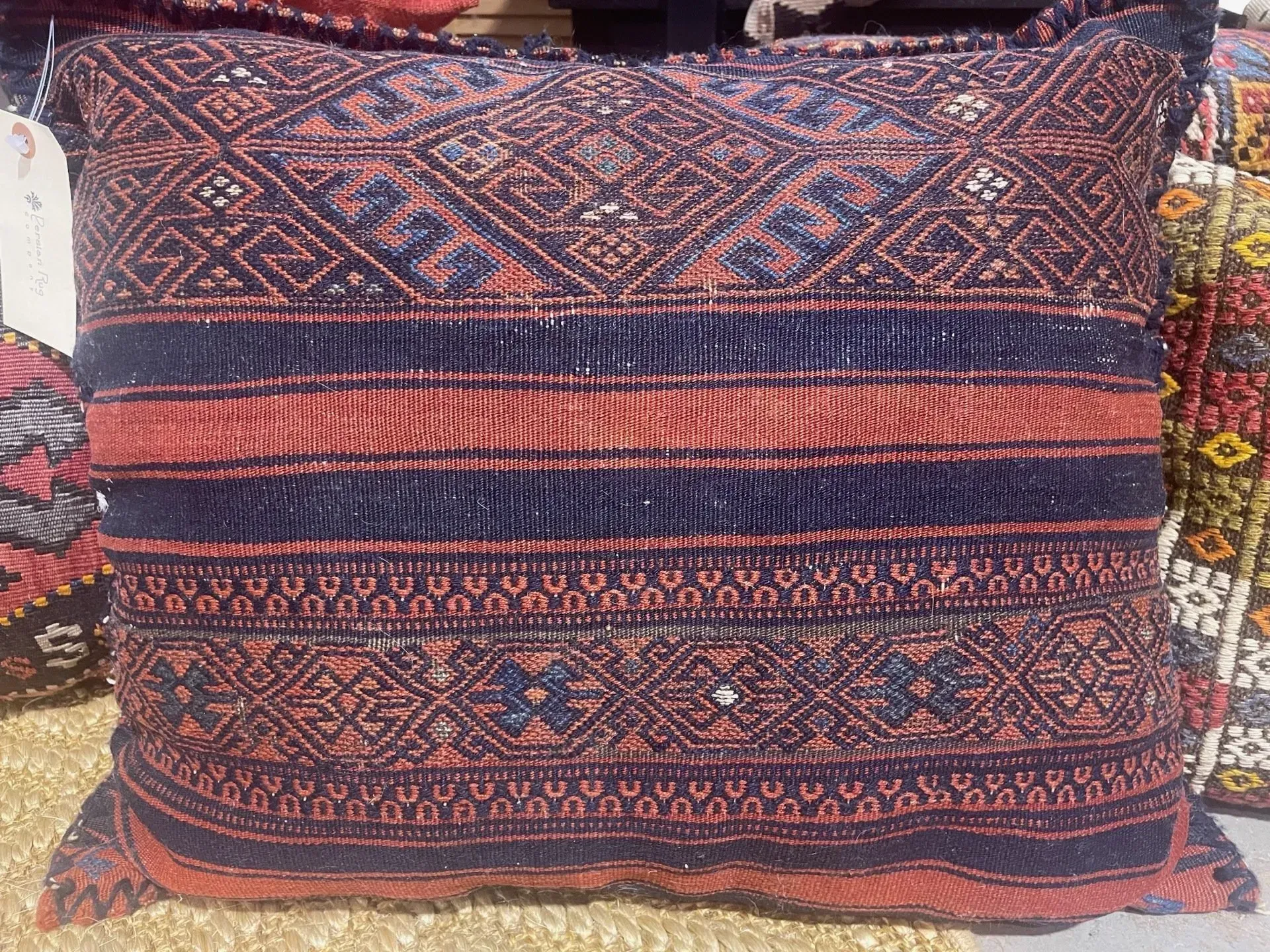 A pillow with a pattern on it is sitting on a table.