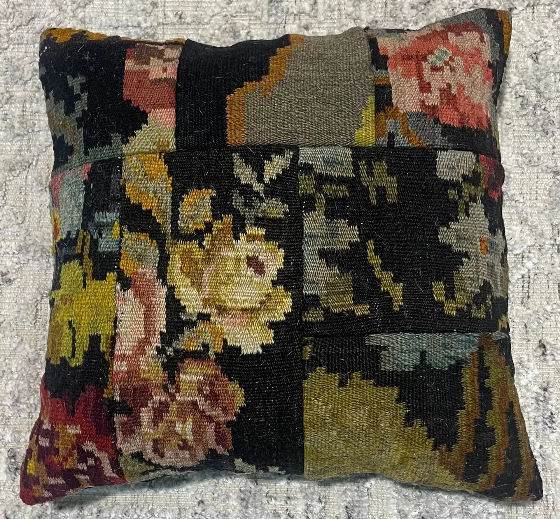 A black pillow with a floral pattern on it.