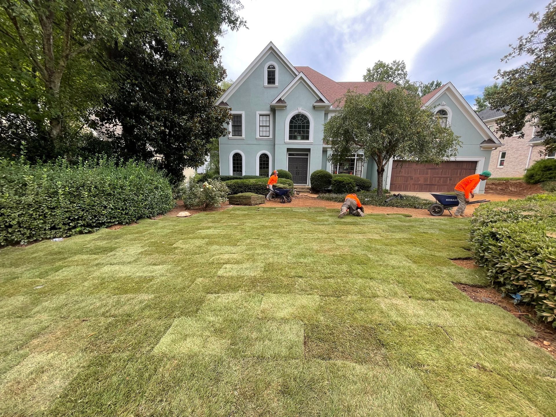 A large house with a lush green lawn in front of it.