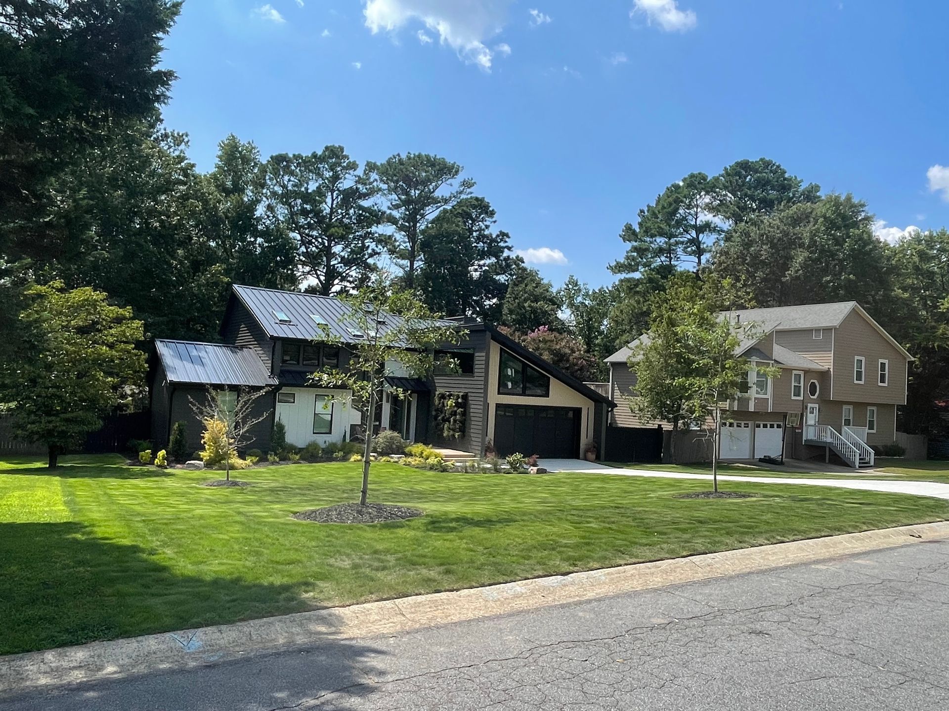 A row of houses on a sunny day with trees in the background
