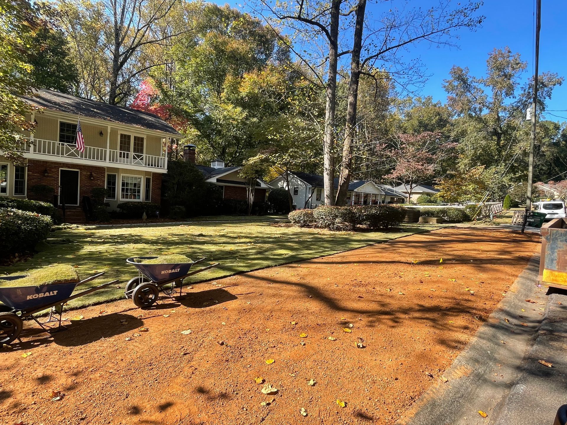 A large house with a lot of dirt in front of it.