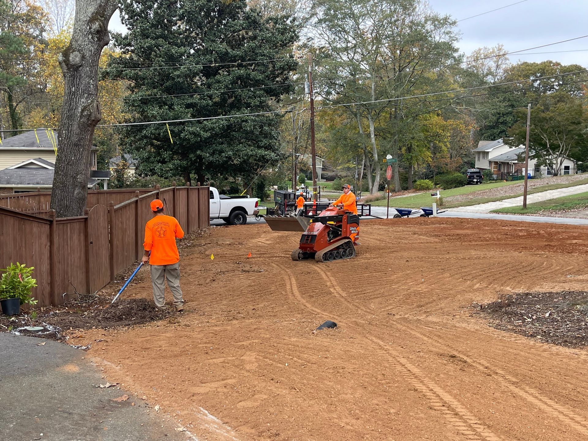 A group of men are working on a dirt road.
