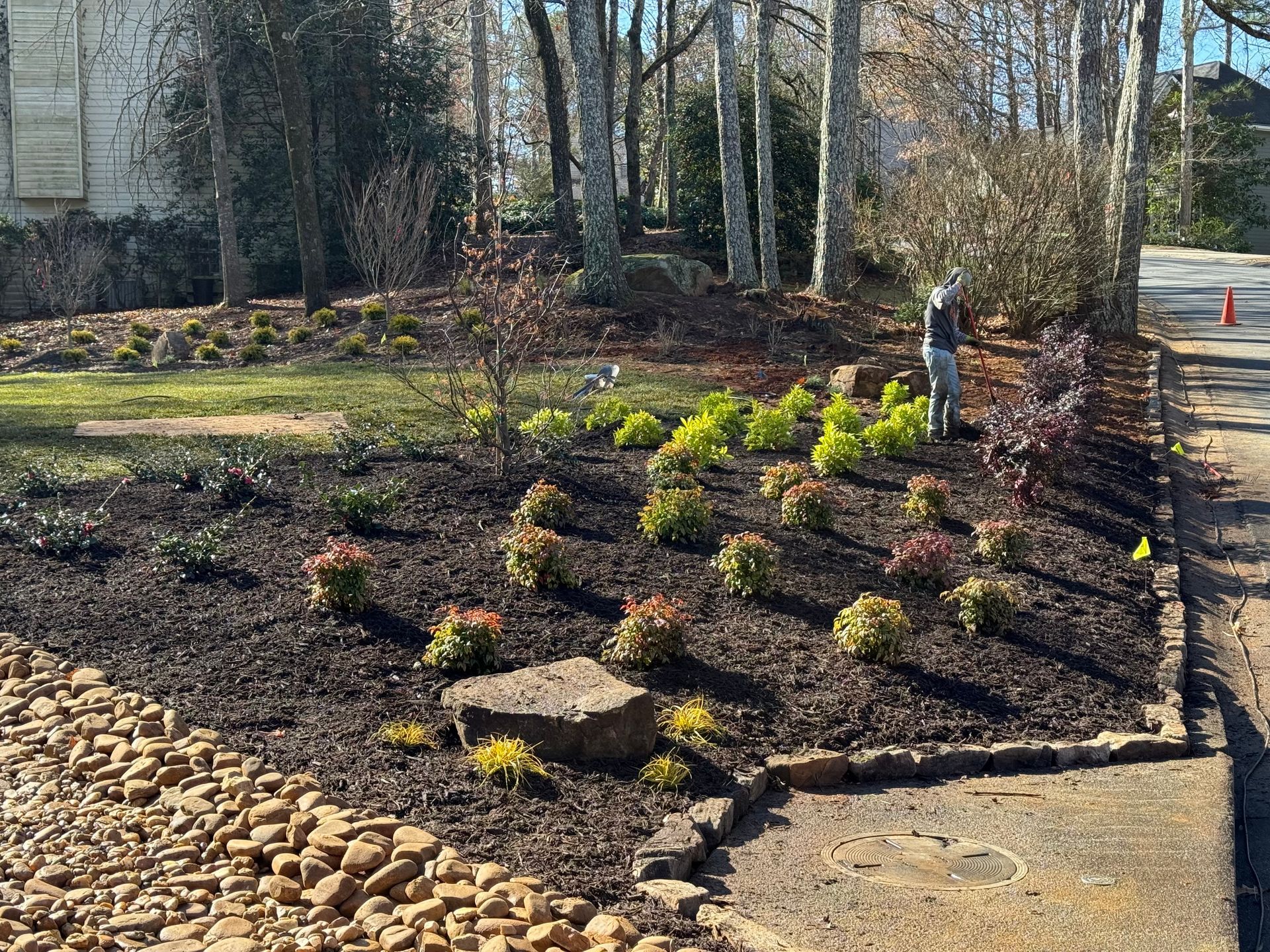 A man is standing in the grass in front of a house.