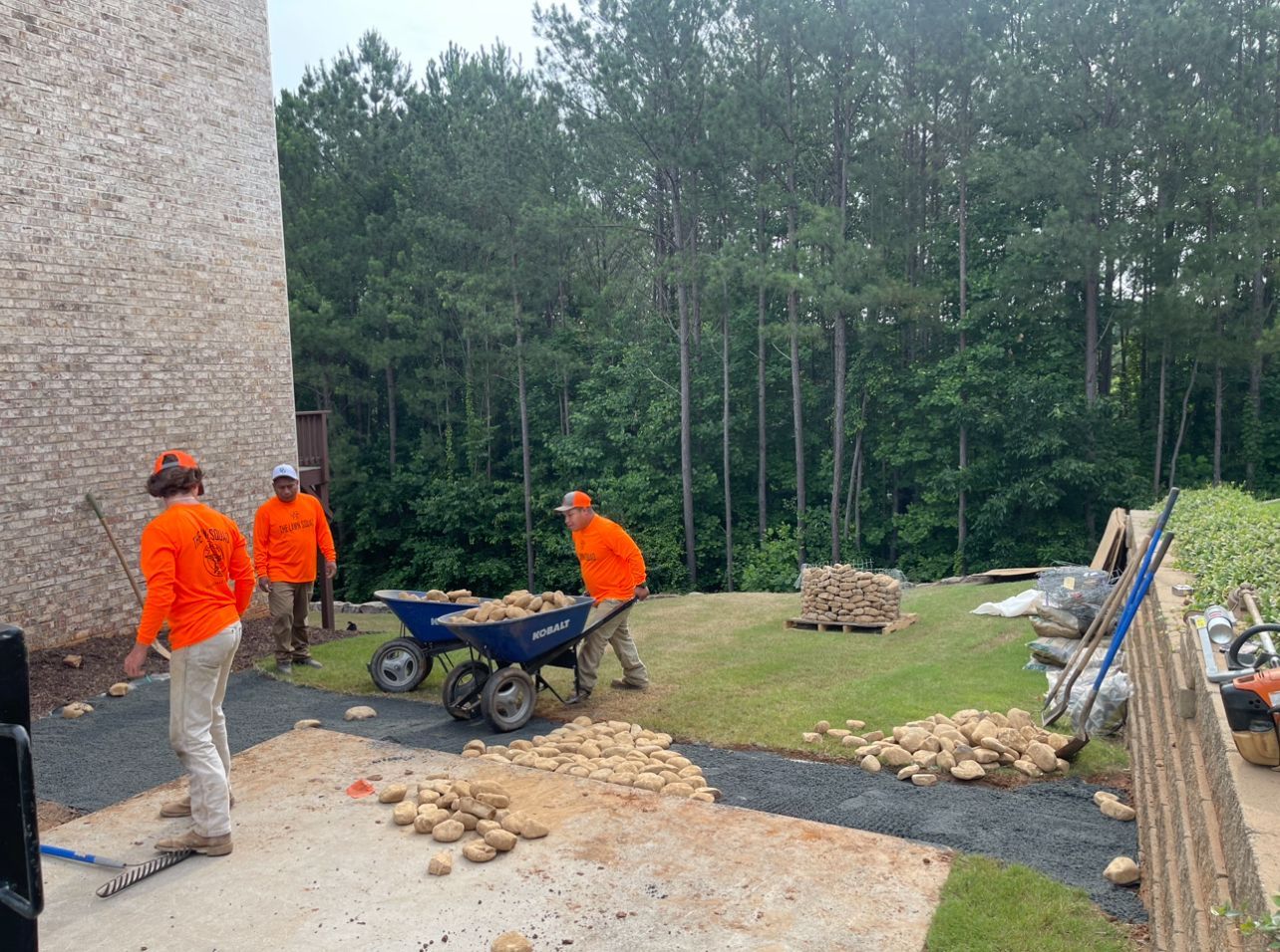 A group of construction workers are working in a yard.