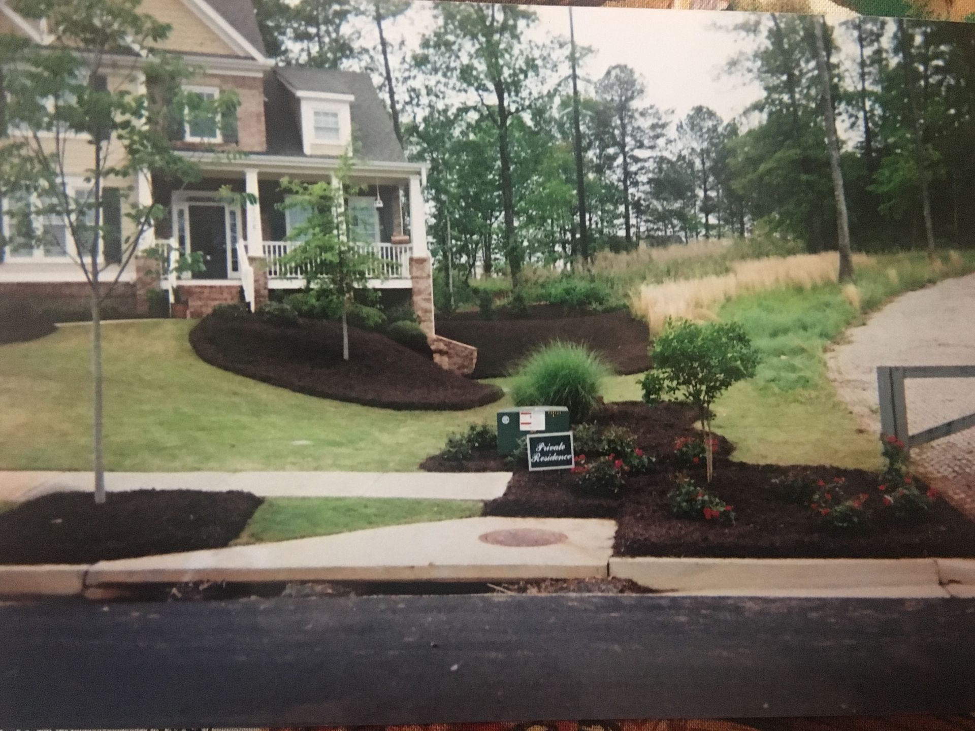 A picture of a house with a mailbox in front of it