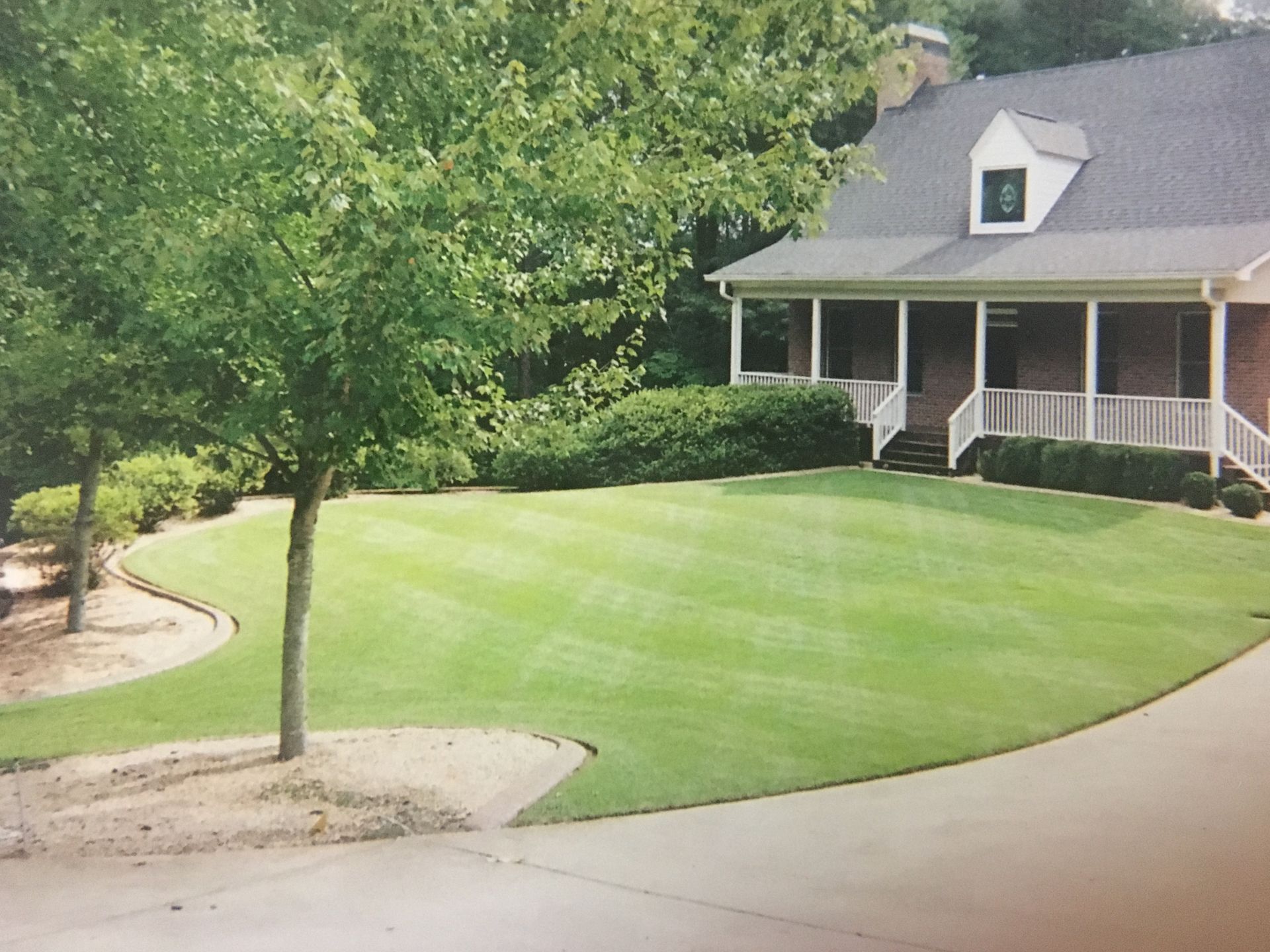 A house with a large lawn in front of it