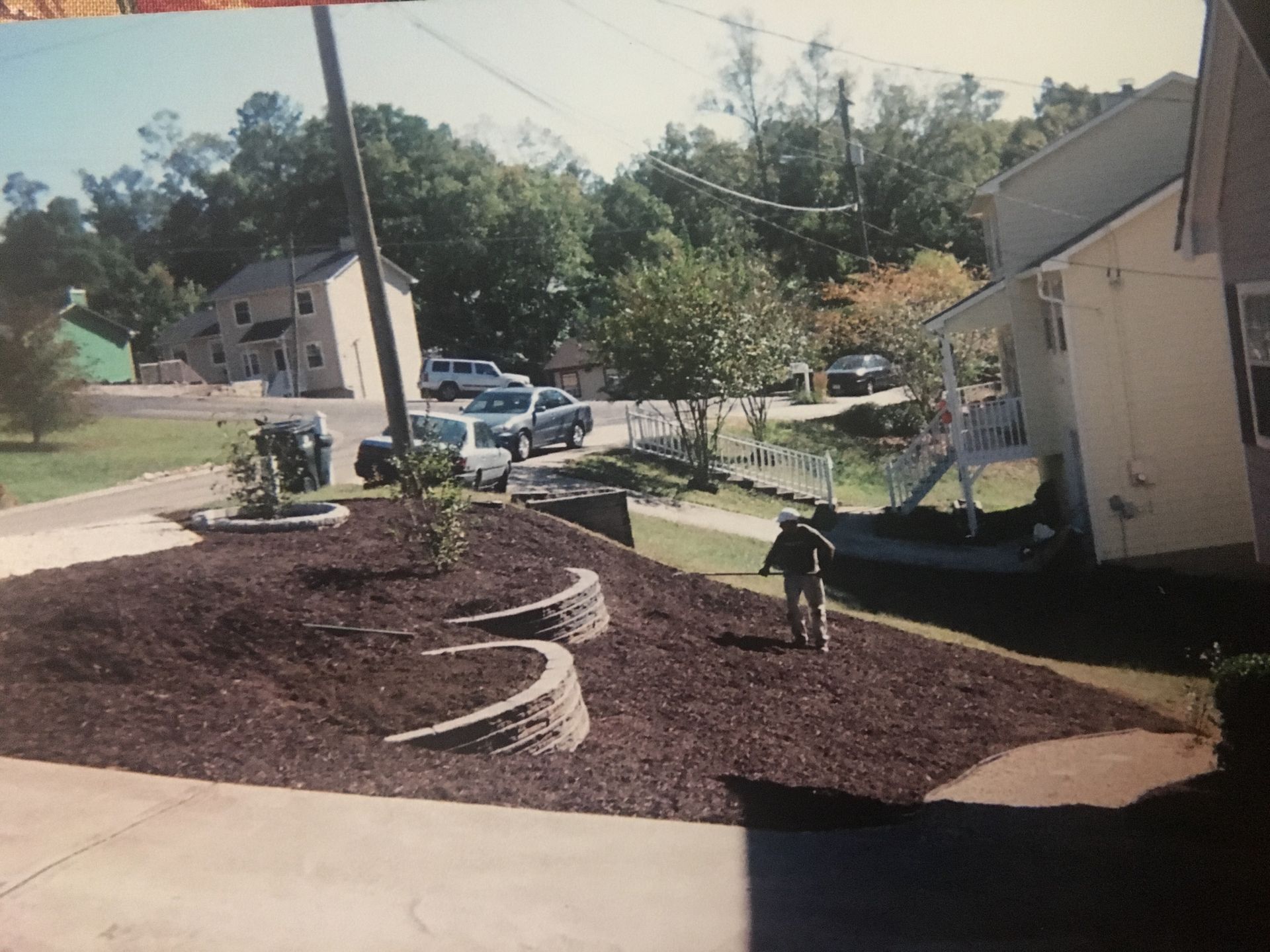 A child is walking down a sidewalk in front of a house