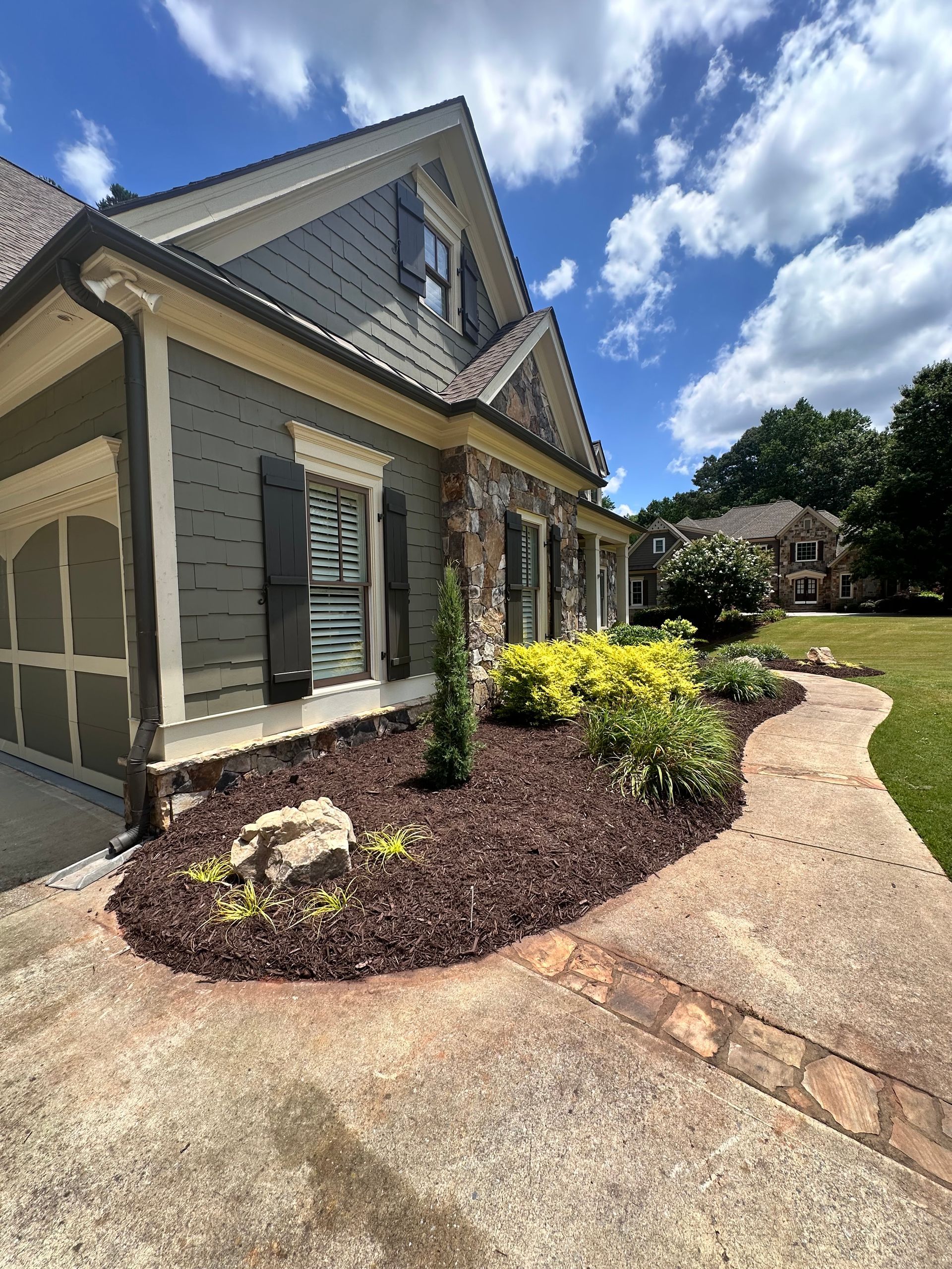 A large house with a walkway leading to it.