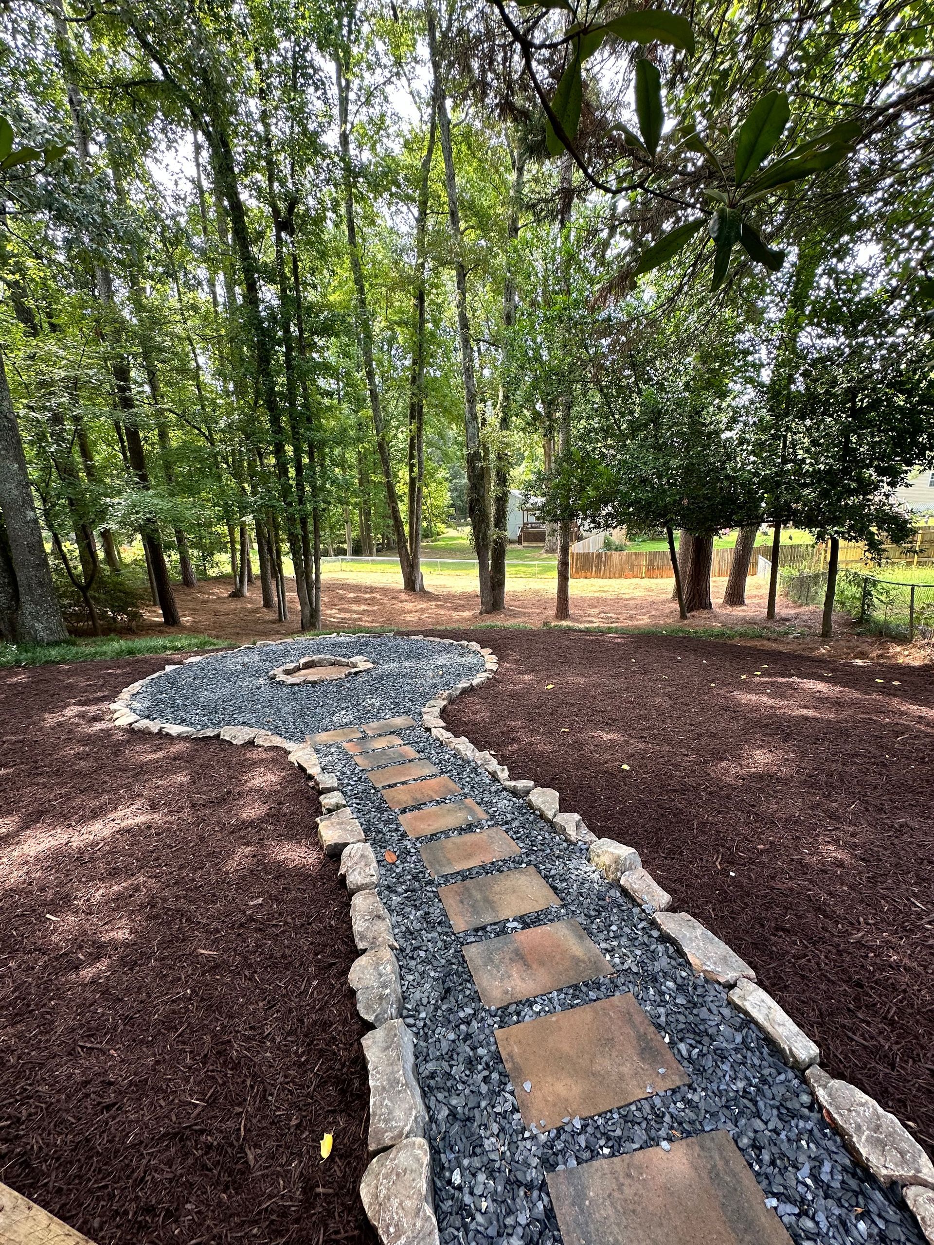 A stone walkway in the middle of a forest.