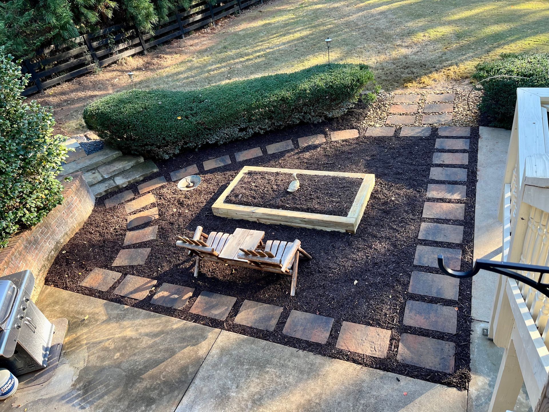 There is a fire pit in the middle of the backyard.