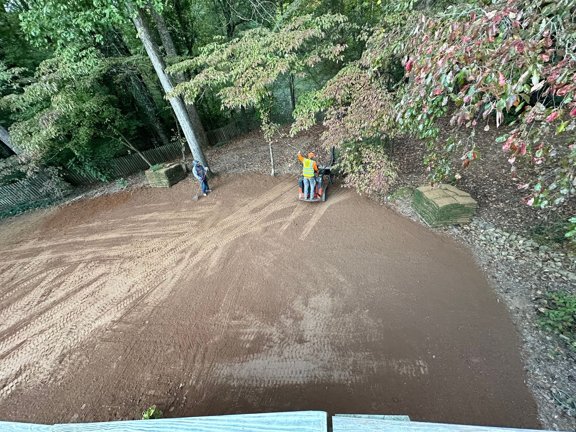 A person in a wheelchair is riding a bike on a dirt road.