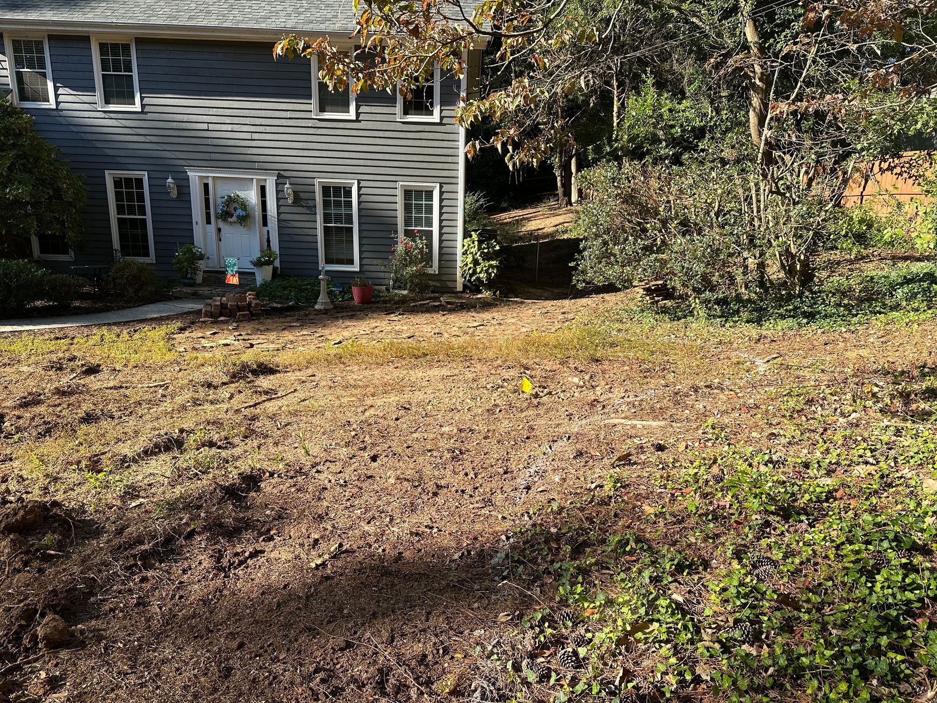 A house with a lot of dirt in front of it.