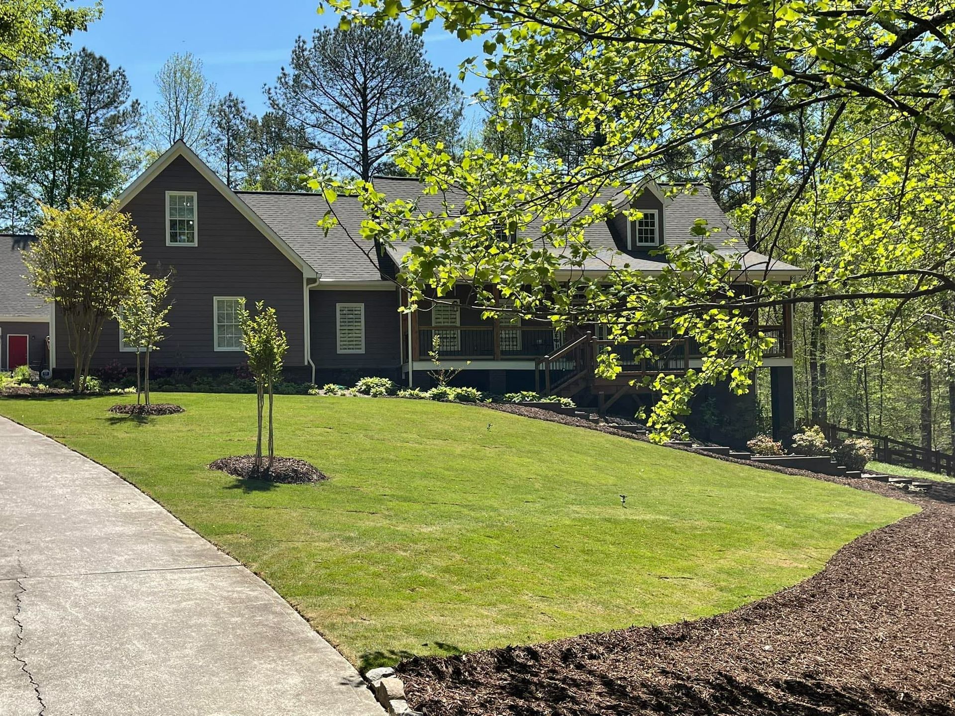 A large house with a lush green lawn in front of it