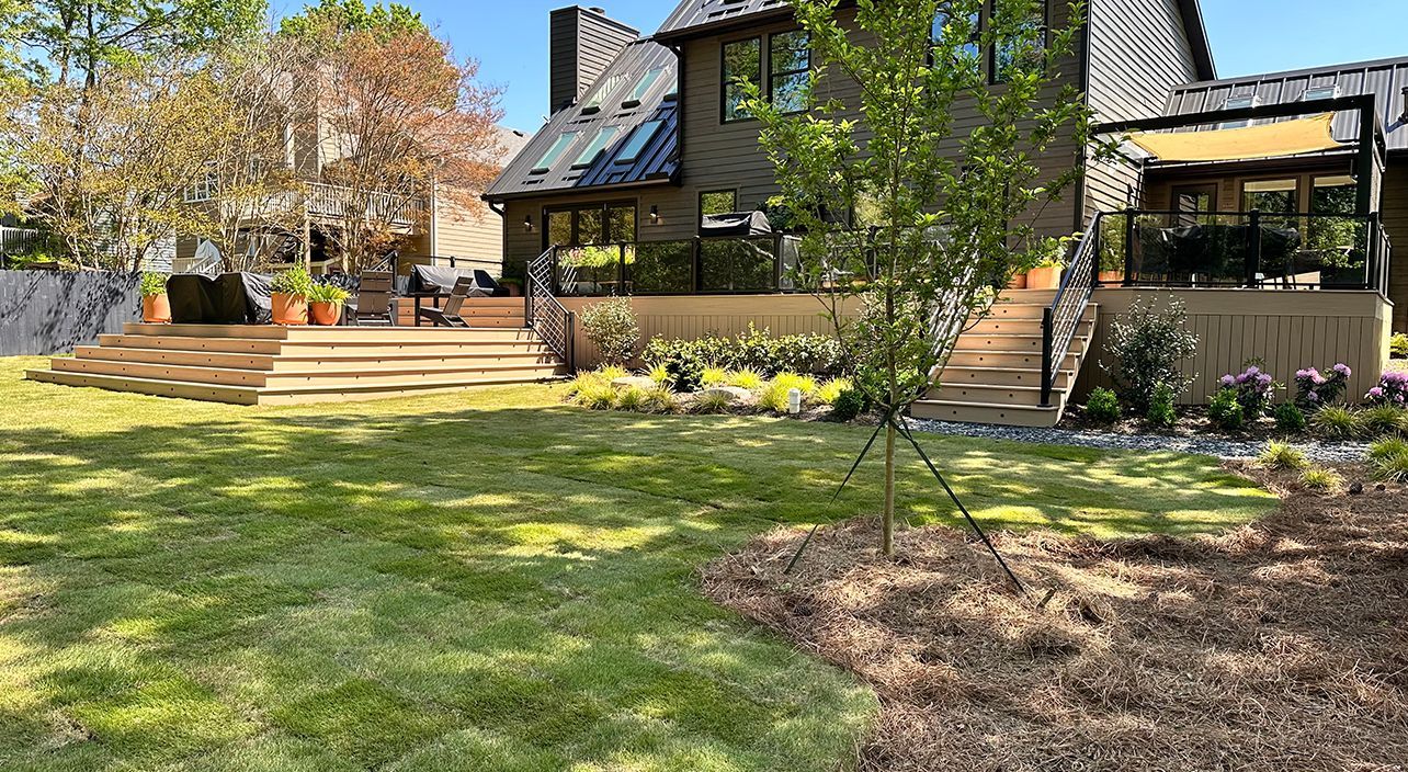 A large house with a large lawn in front of it.