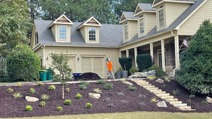 A man is standing in front of a large house.