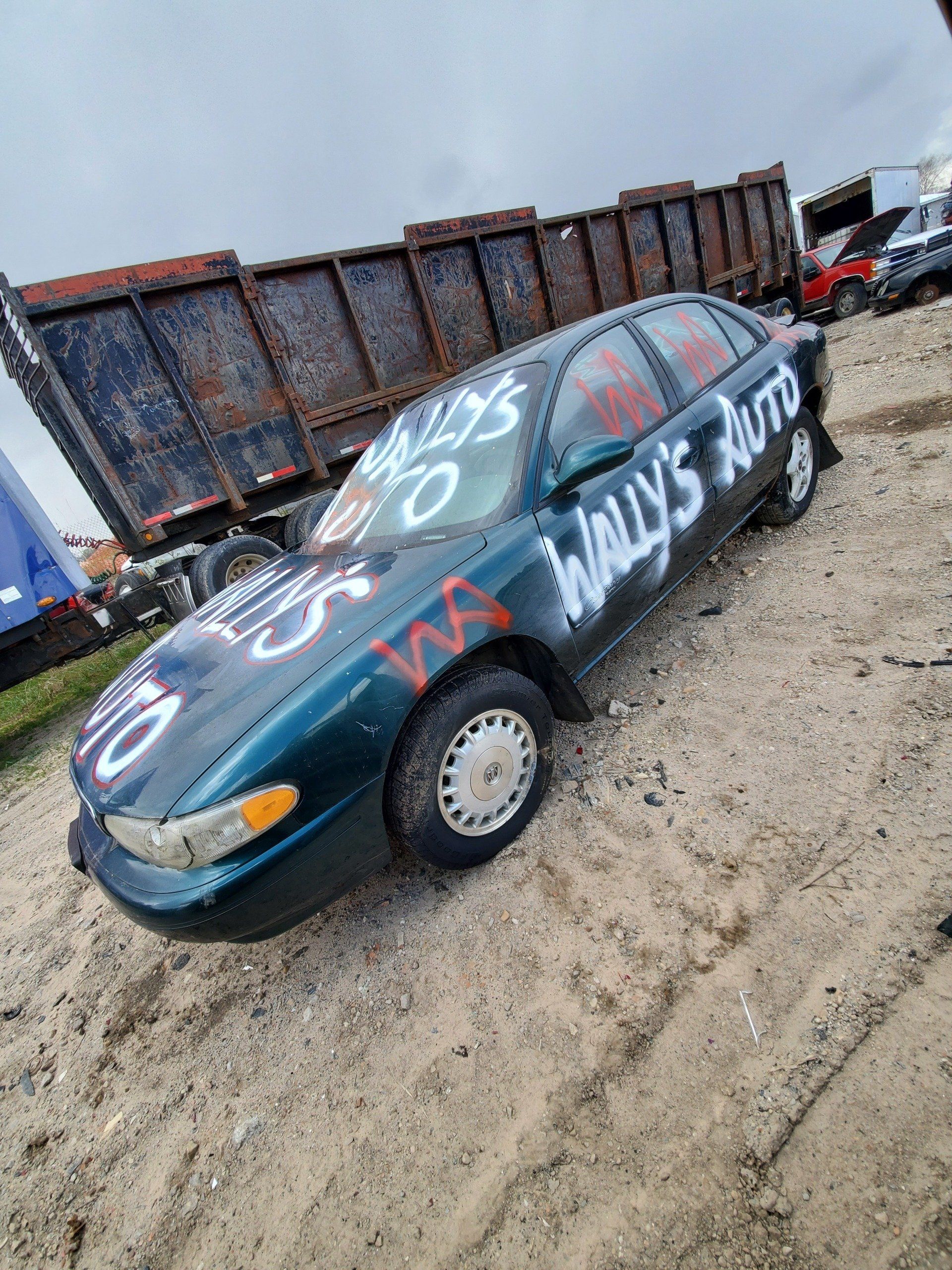Vandalized blue green car