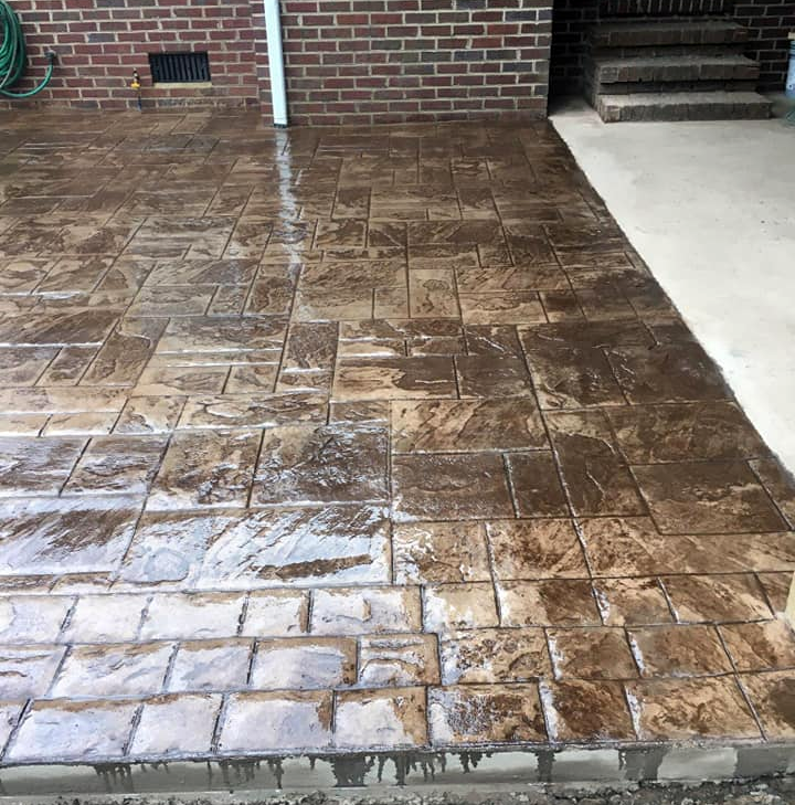 A brick driveway with a hose next to it