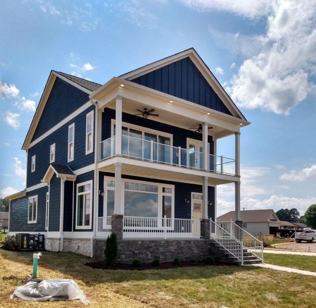 A large blue and white house with a balcony