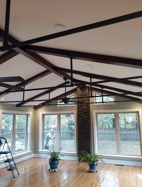 A living room with hardwood floors and a ceiling fan
