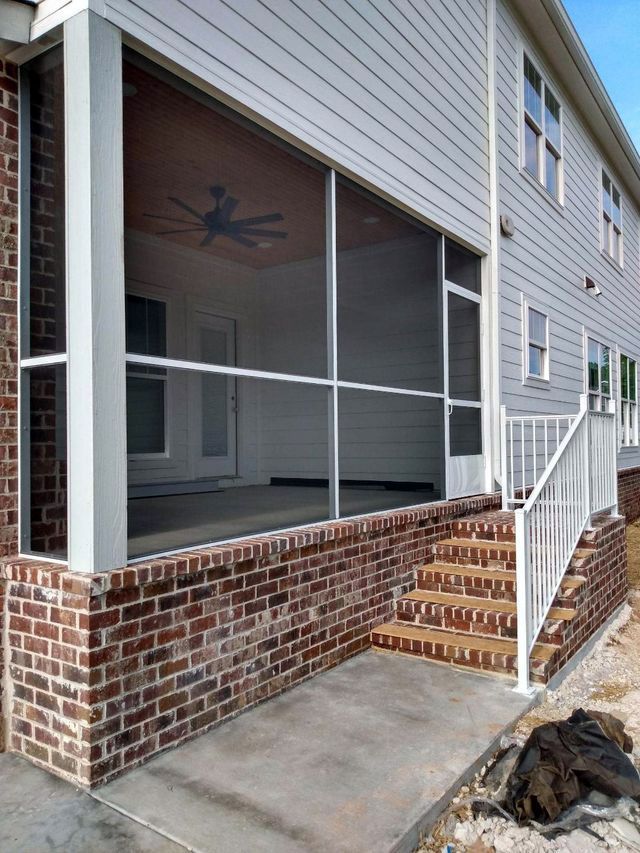 A screened in porch with stairs leading up to it