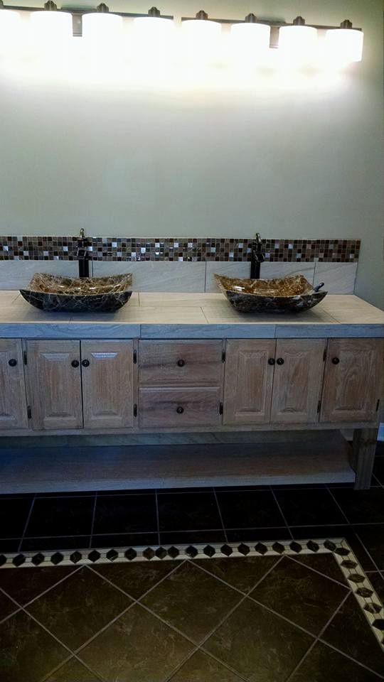 A bathroom with two sinks and a tiled floor.