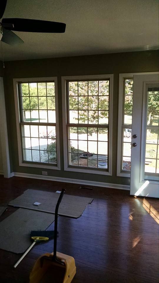 A living room with hardwood floors and a ceiling fan.
