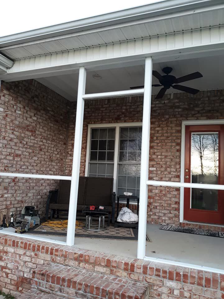 A brick house with a porch and a ceiling fan
