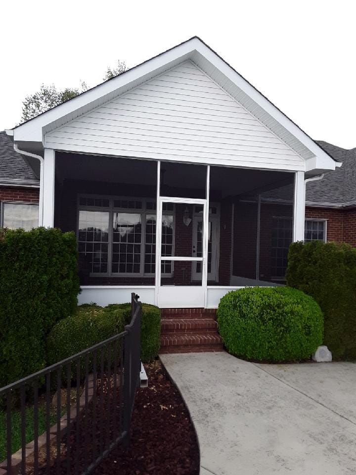 A house with a screened in porch and stairs