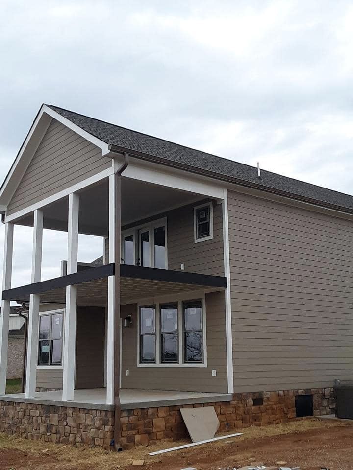 A large house with a porch and a lot of windows