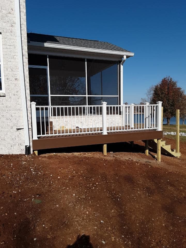A screened in porch on the side of a house