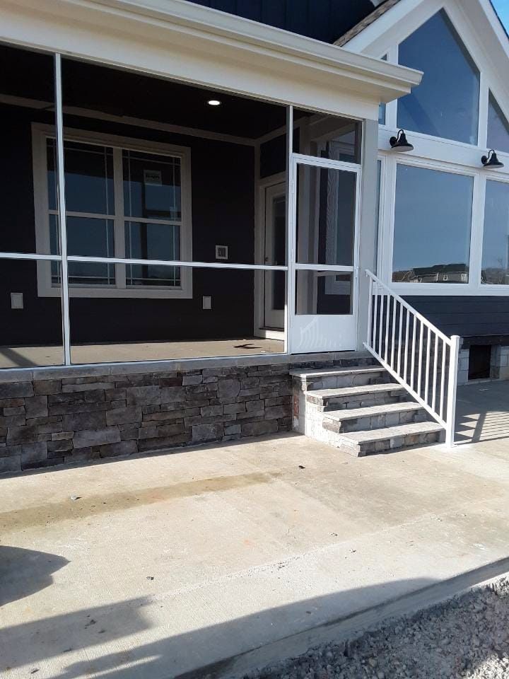 A house with a screened in porch and stairs