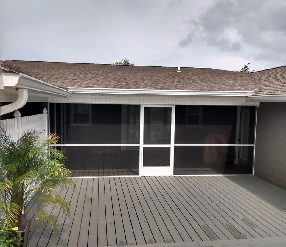 A screened in porch in front of a house