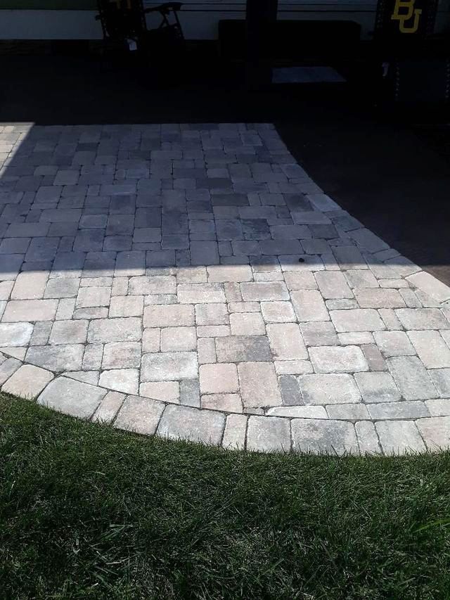 A brick walkway with a circle in the middle of it