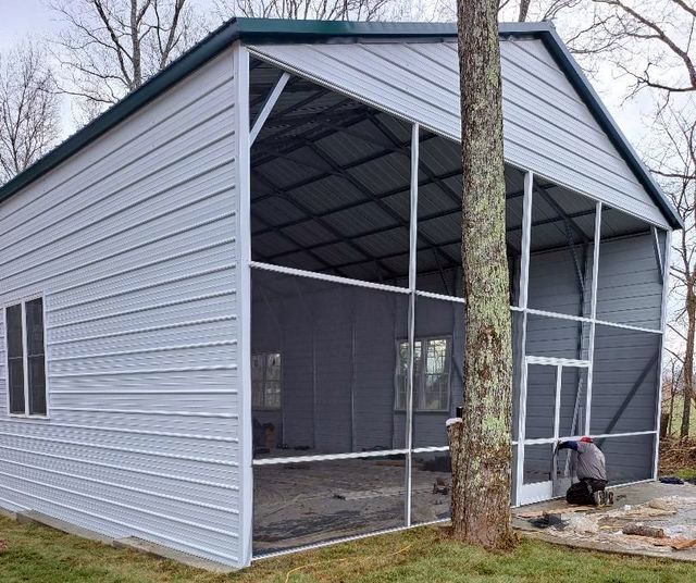 A screened in porch with a tree in front of it
