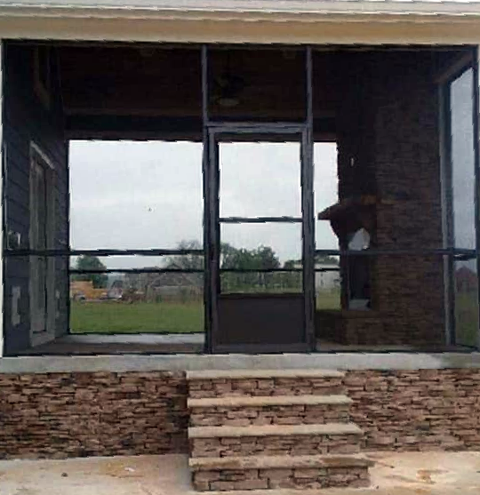 A screened in porch with stairs leading up to it
