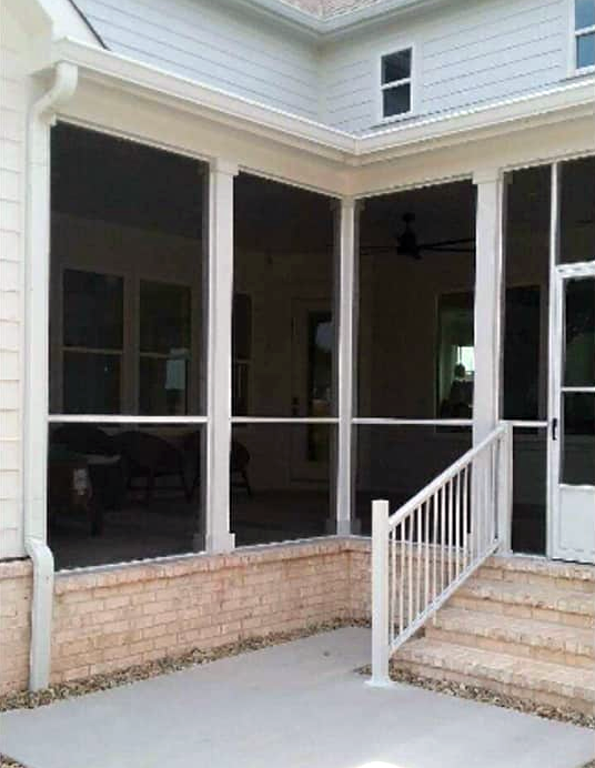 A screened in porch with stairs leading up to it