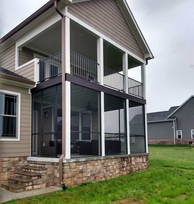 A house with a screened in porch and stairs