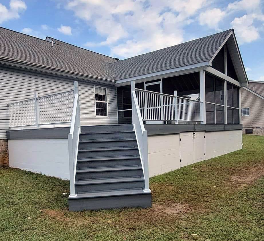 A house with a screened in porch and stairs leading to it.
