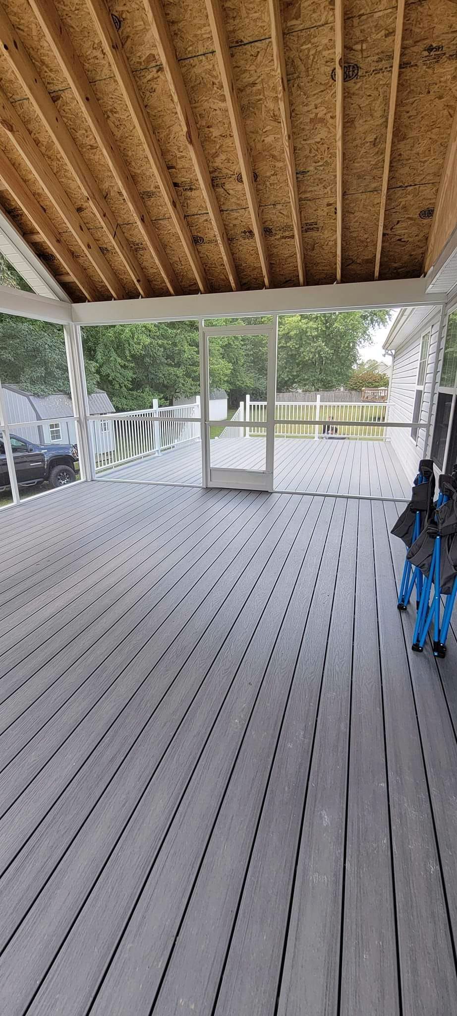 A porch with a lot of umbrellas on it.